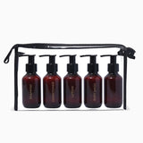 Set of 5 amber bottles with black pumps in a black travel case on a white background