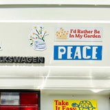 Decorative stickers on a Volkswagen vehicle, including 'I'd Rather Be In My Garden', 'PEACE', and 'Take It Easy'