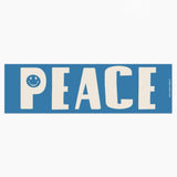 Blue sign with 'PEACE' and a smiley face on a white background