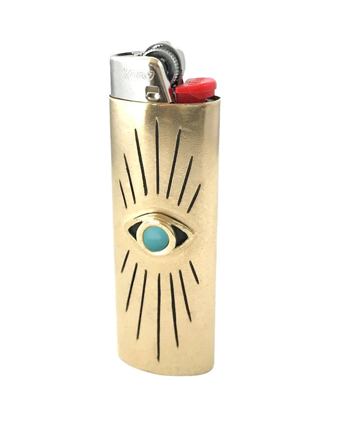 Brass lighter with eye design on a white background