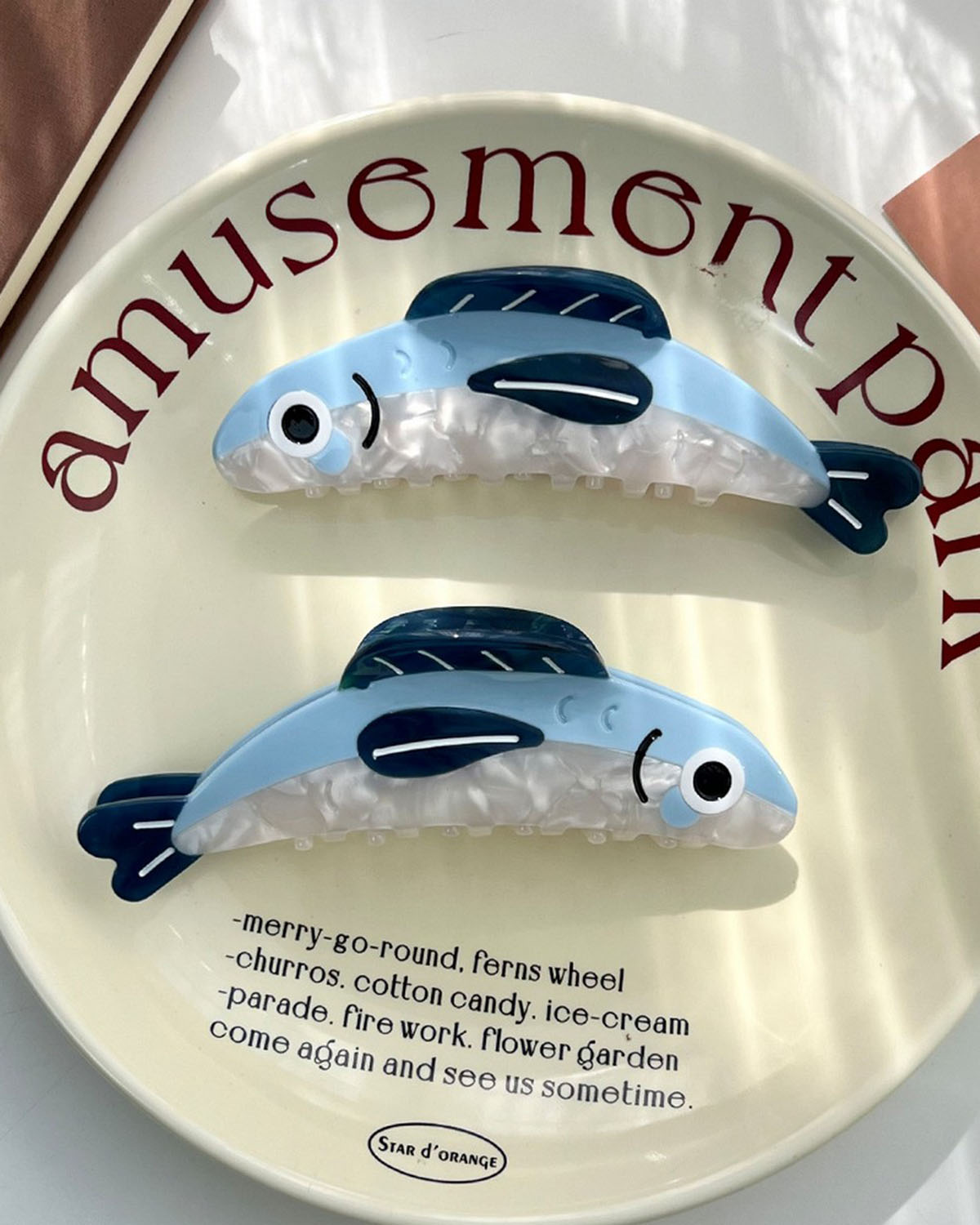 Decorative plate with fish design and 'amusement park' text