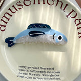 Toy whale on a plate with 'amusement park' text and a list of attractions