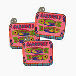 Three pink coasters with fish illustrations and 'Sardines' text on a white background