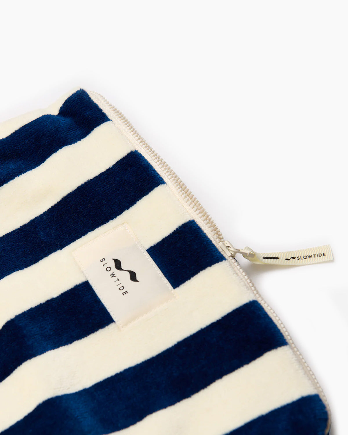 Navy and white striped pouch with a visible brand label on a white background