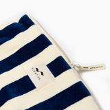 Navy and white striped pouch with a visible brand label on a white background