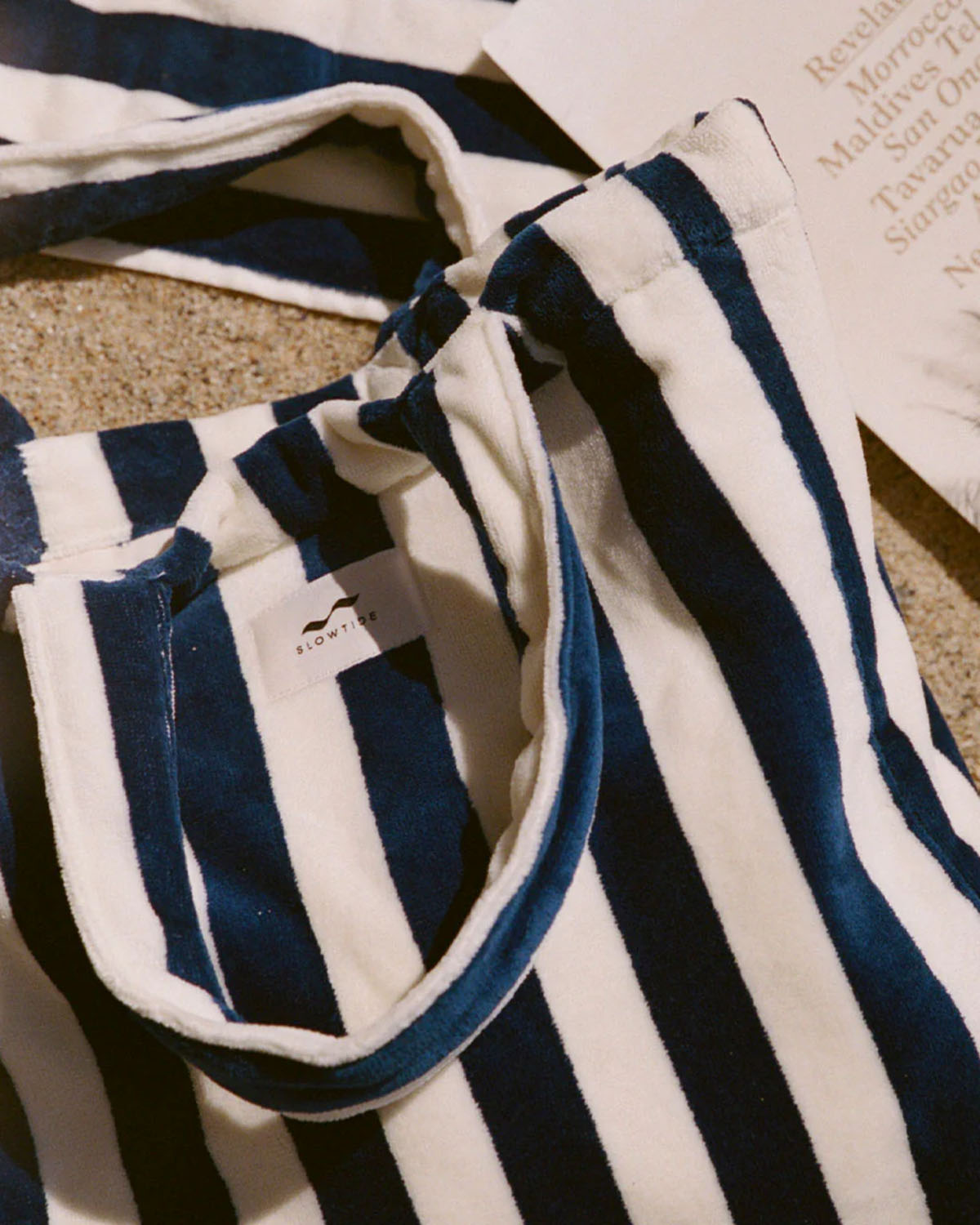 Close-up of a navy and white striped garment with a brand logo