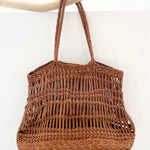 Leather woven bag on white background