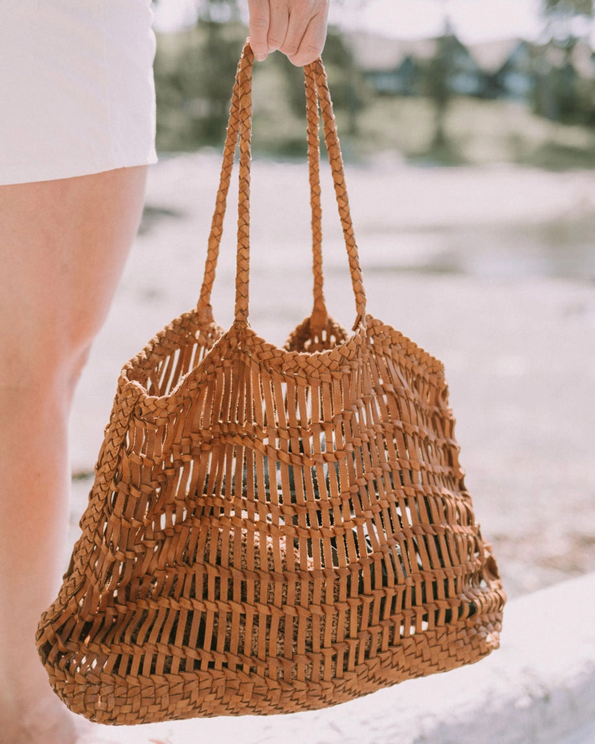 Model holding leather woven bag 