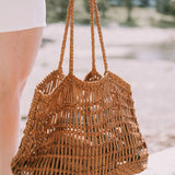 Model holding leather woven bag 