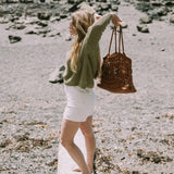 Girl holding Leather woven bag
