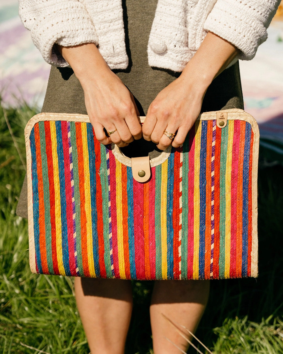 Model holding palm fiber woven red fiesta bag 
