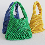 Three colorful mesh bags in green, blue, and yellow on a light background