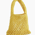 Yellow mesh bag on a light background