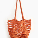Orange woven tote bag on a white background