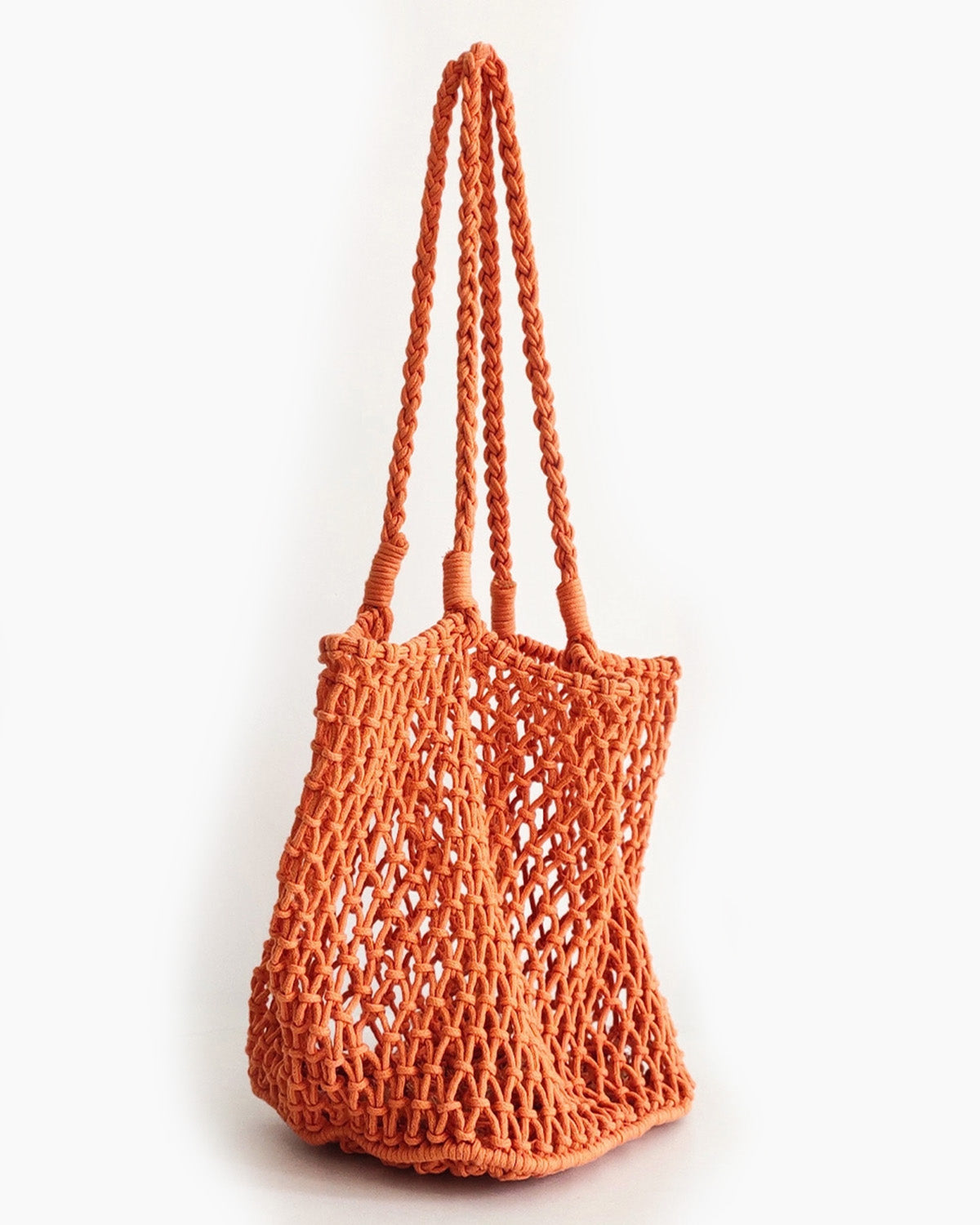 Orange woven bag on a white background