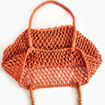 Orange mesh bag on a white background