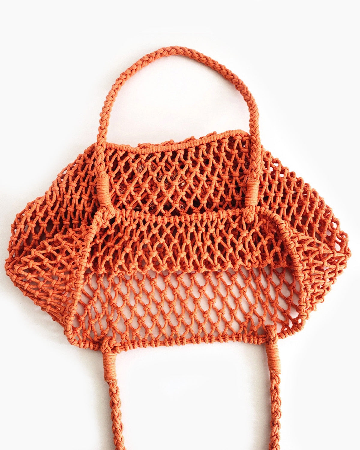 Orange mesh bag on a white background