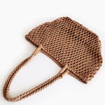 Brown woven handbag on a white background