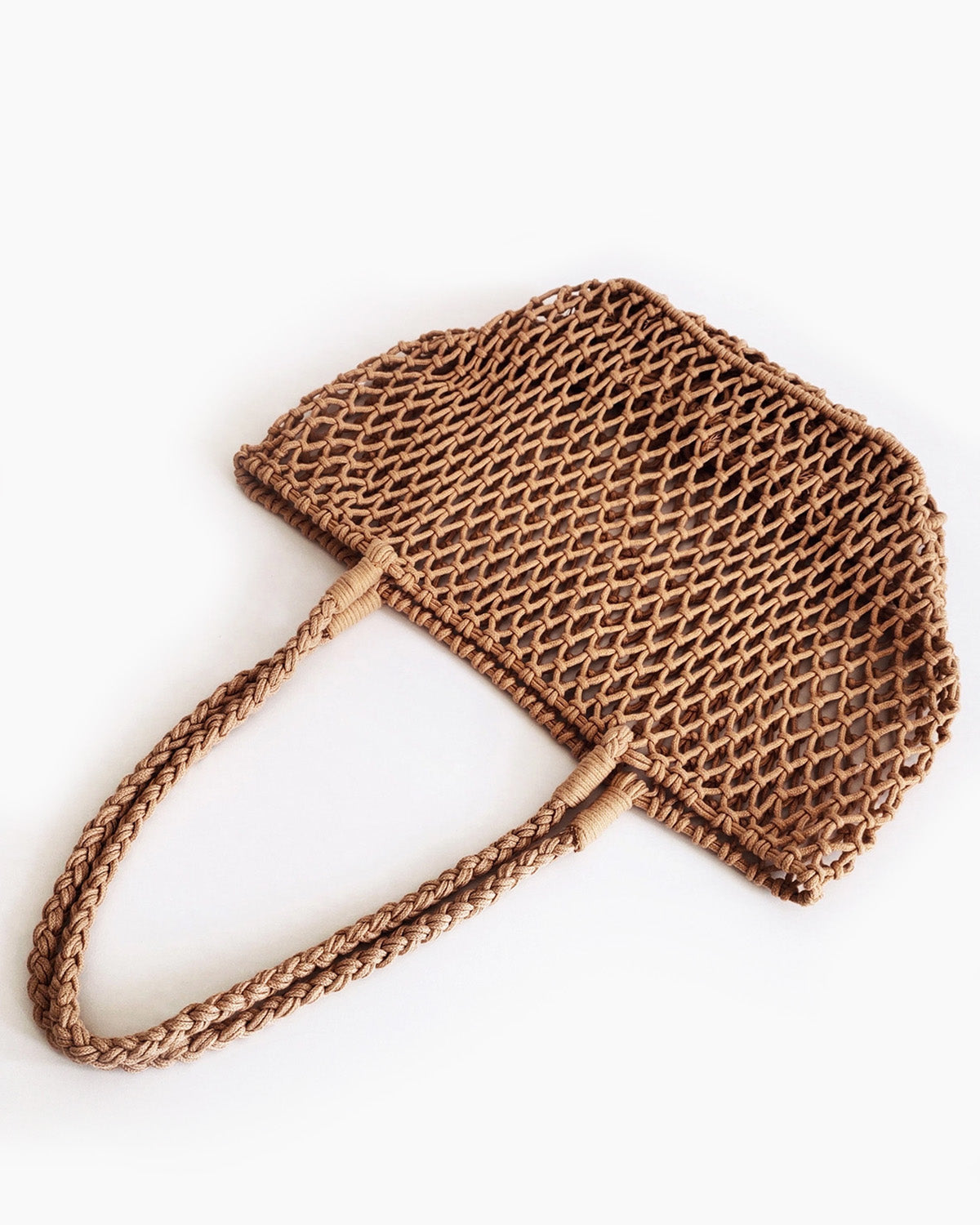 Brown woven handbag on a white background