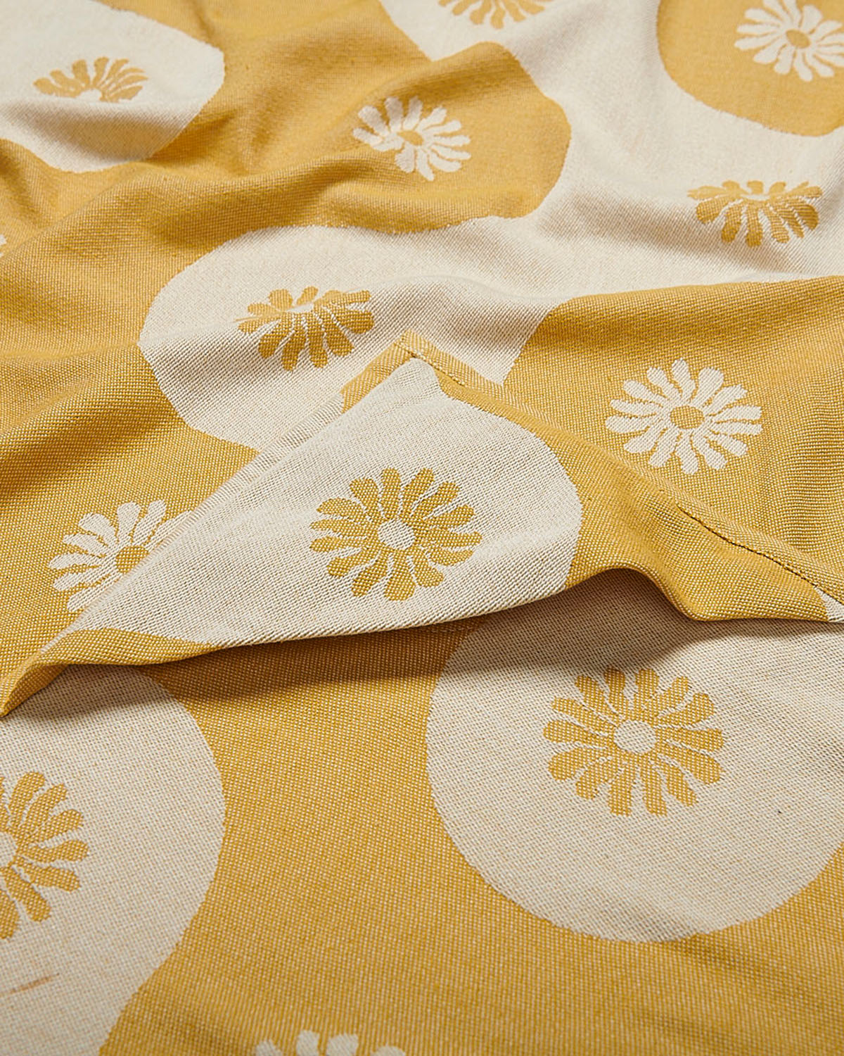 Yellow and white fabric with floral patterns