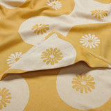Yellow and white fabric with floral patterns