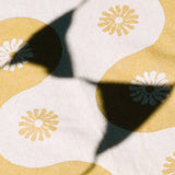 Close-up of a fabric with floral pattern on a yellow background