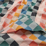 Colorful checkered fabric with a mix of pink, blue, green, and orange patterns