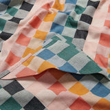 Colorful checkered fabric with a mix of pink, blue, green, and orange patterns