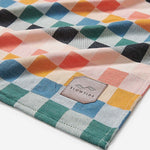 Colorful checkered fabric with a 'Slowtide' logo in the corner