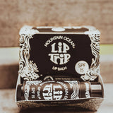 Mountain Ocean Lip Trip lip balm packaging on a wooden surface