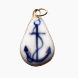Teardrop-shaped porcelain pendant with blue anchor design on a white background