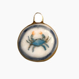 Decorative pendant with a blue crab design on a white background