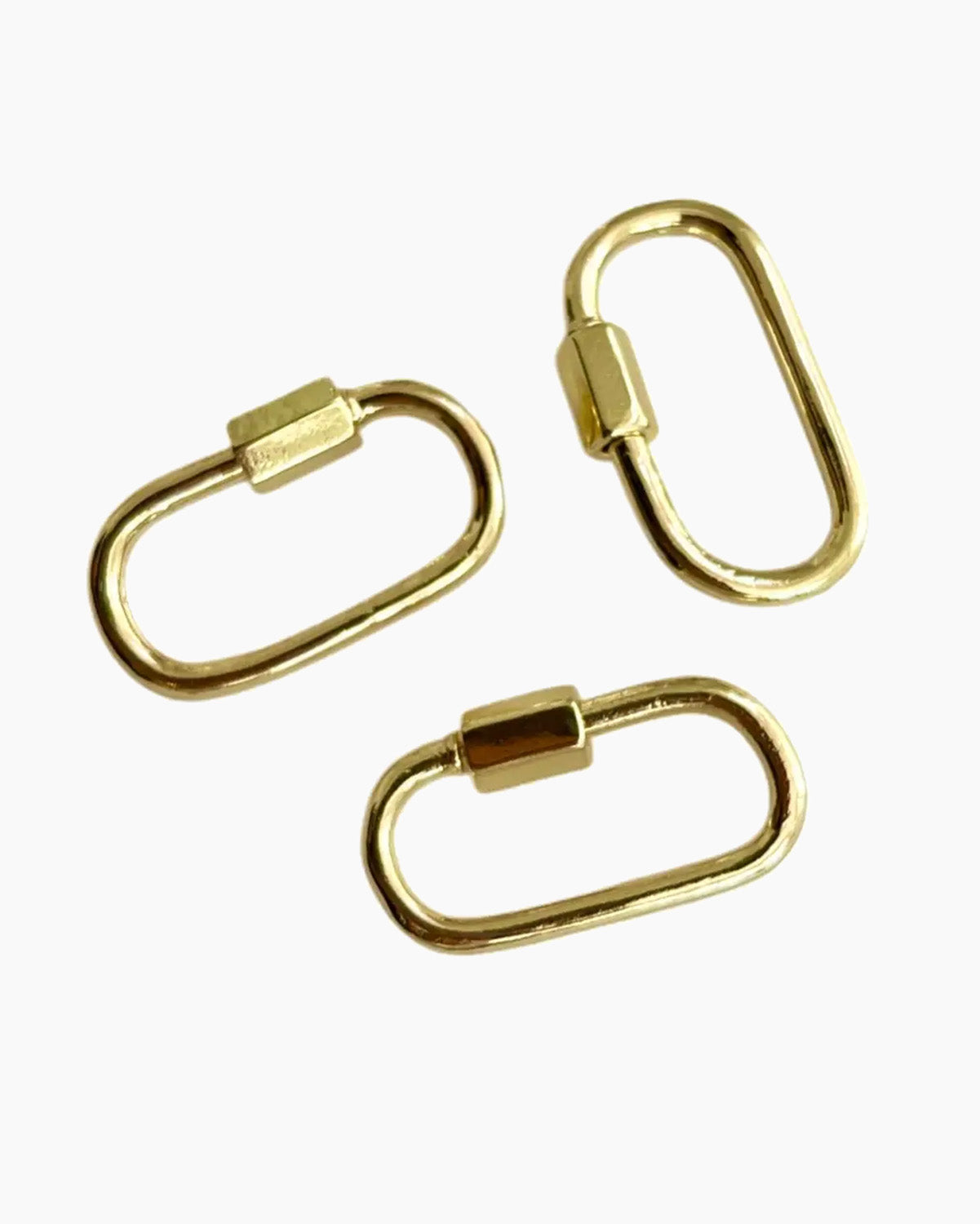 Three gold carabiner on a white background