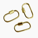 Three gold carabiner on a white background