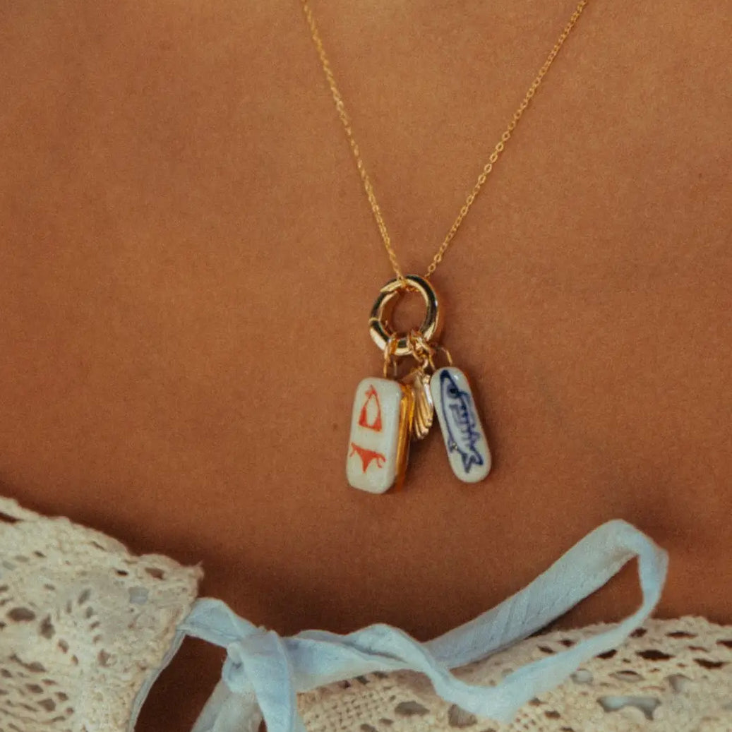 Necklace with two small rectangular charms on a brown background