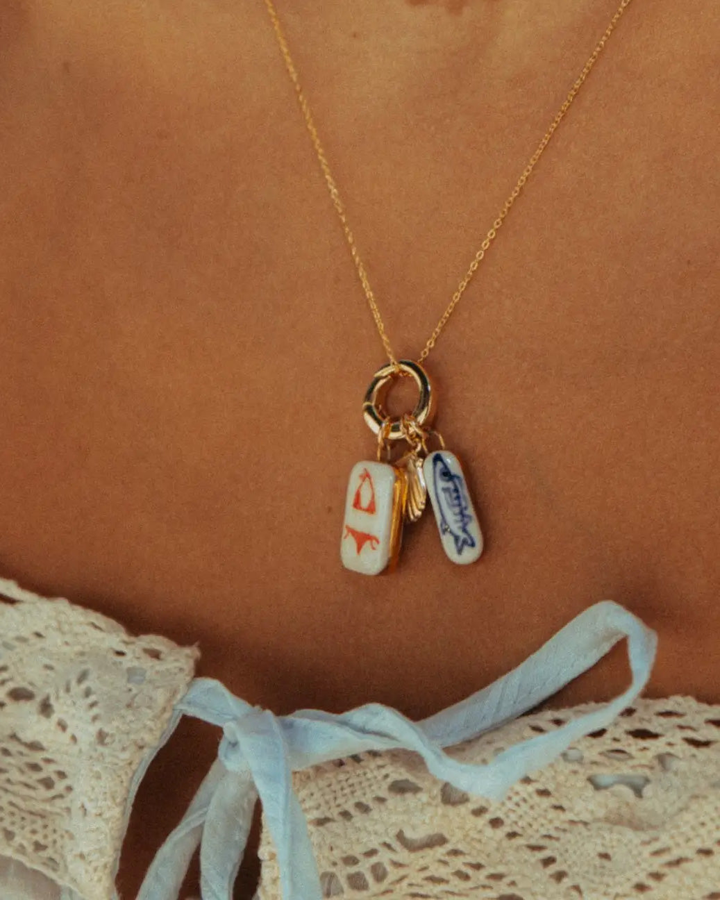Necklace with two small rectangular charms on a brown background