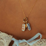 Necklace with two small rectangular charms on a brown background