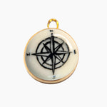 Pendant with compass design on a white background