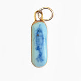 Blue and white pendant with gold chain on a white background