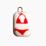 Pendant with red bikini design on a white background