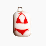 Pendant with red bikini design on a white background