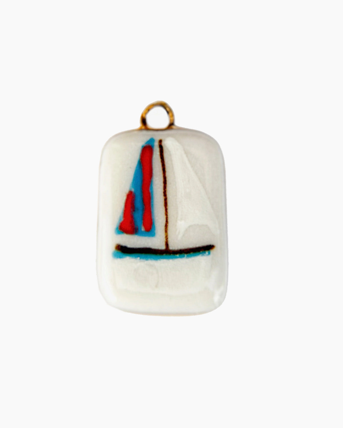 Small ceramic pendant with a sailboat design on a white background