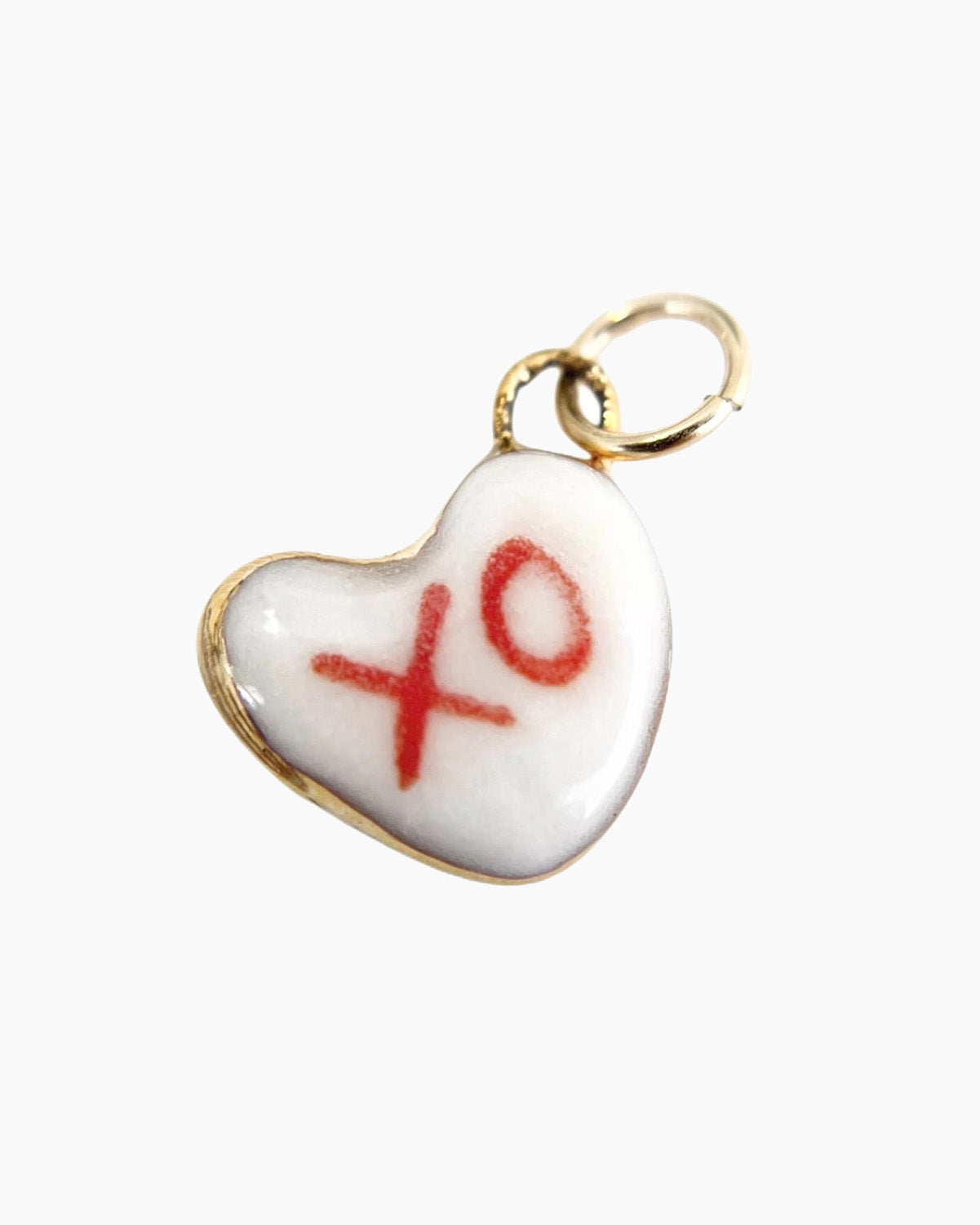 Heart-shaped charm with 'xo' on a white background