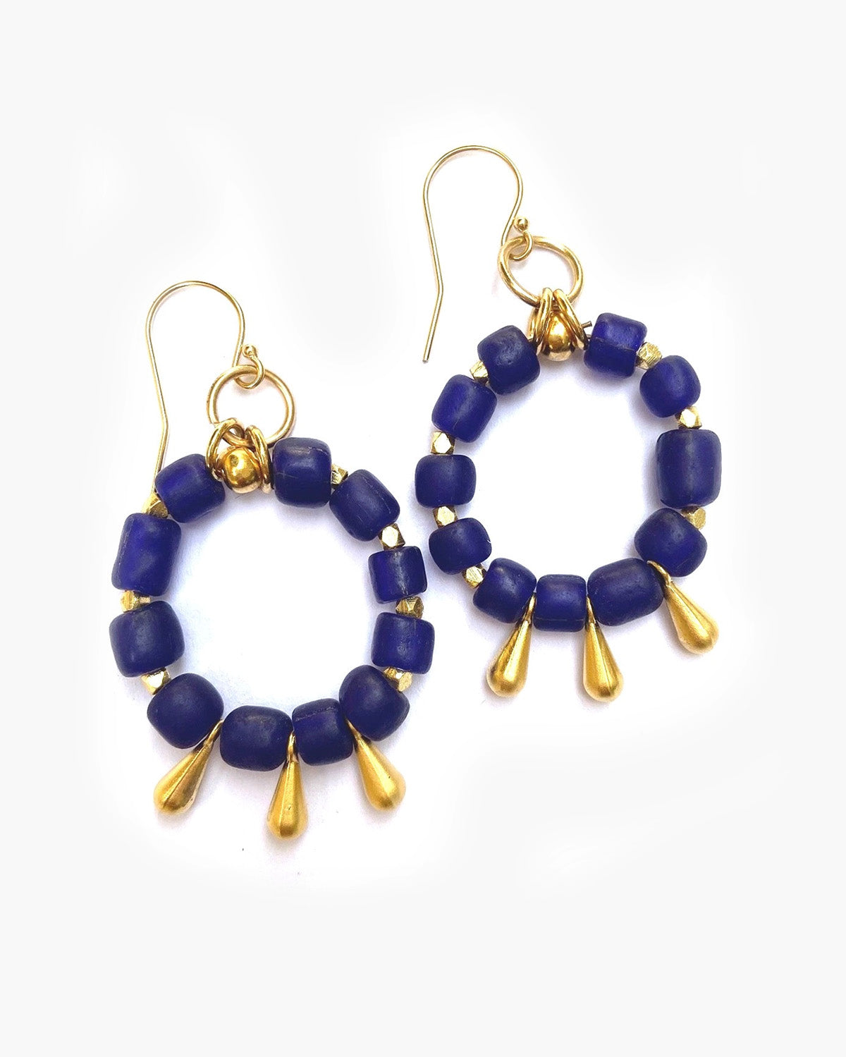 Pair of blue beaded earrings with gold accents on a white background