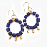 Pair of blue beaded earrings with gold accents on a white background