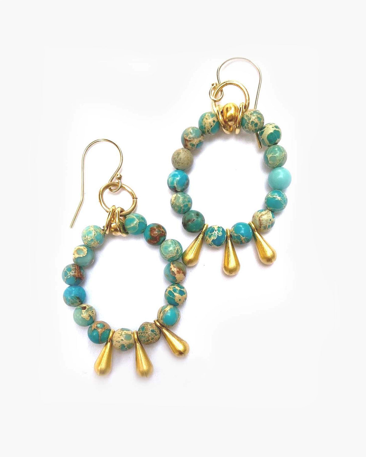 Turquoise and gold beaded hoop earrings on a white background