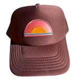 Brown cap with a colorful sun emblem on a white background