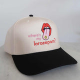Beige and black cap with a graphic of a tongue and text on a white background