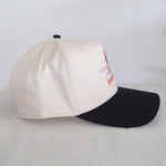 Two-tone cap with white front and black back on a light gray background