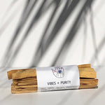 Wooden incense sticks with a white label on a light background